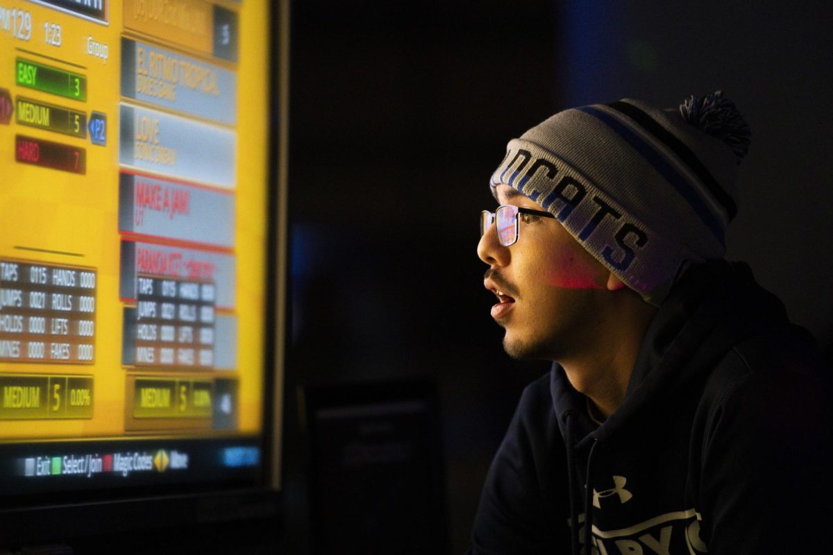 A student chooses a song to break-dance to during Rhythm Riot on Friday, Dec. 6, 2024, at UKFCU Esports Lounge in Lexington, Kentucky. Photo by Christian Kantosky | Assistant Photo Editor