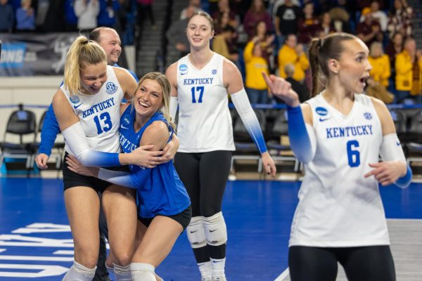 Kentucky Wildcats outside hitter Erin Lamb (13) and libero Molly Tuozzo (12) celebrate their win during the Kentucky vs Minnesota volleyball game on Friday, Dec. 6, 2024, at Historical Memorial Coliseum in Lexington, Kentucky. Kentucky won 3-1. Photo by Sydney Yonker | Staff