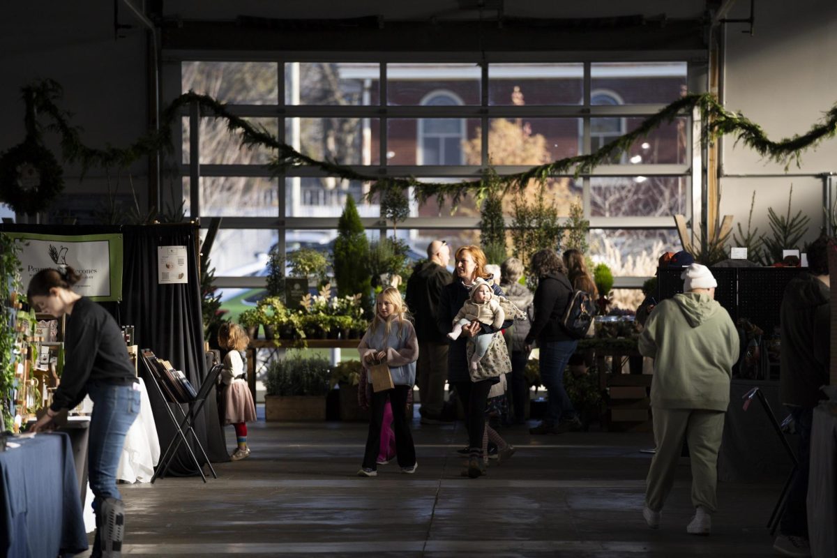 Attendees walk through the various booths during the Crafted Social Winter Market on Saturday, Dec. 7, 2024, at Greyline Station in Lexington, Kentucky. Photo by Christian Kantosky | Assistant Photo Editor