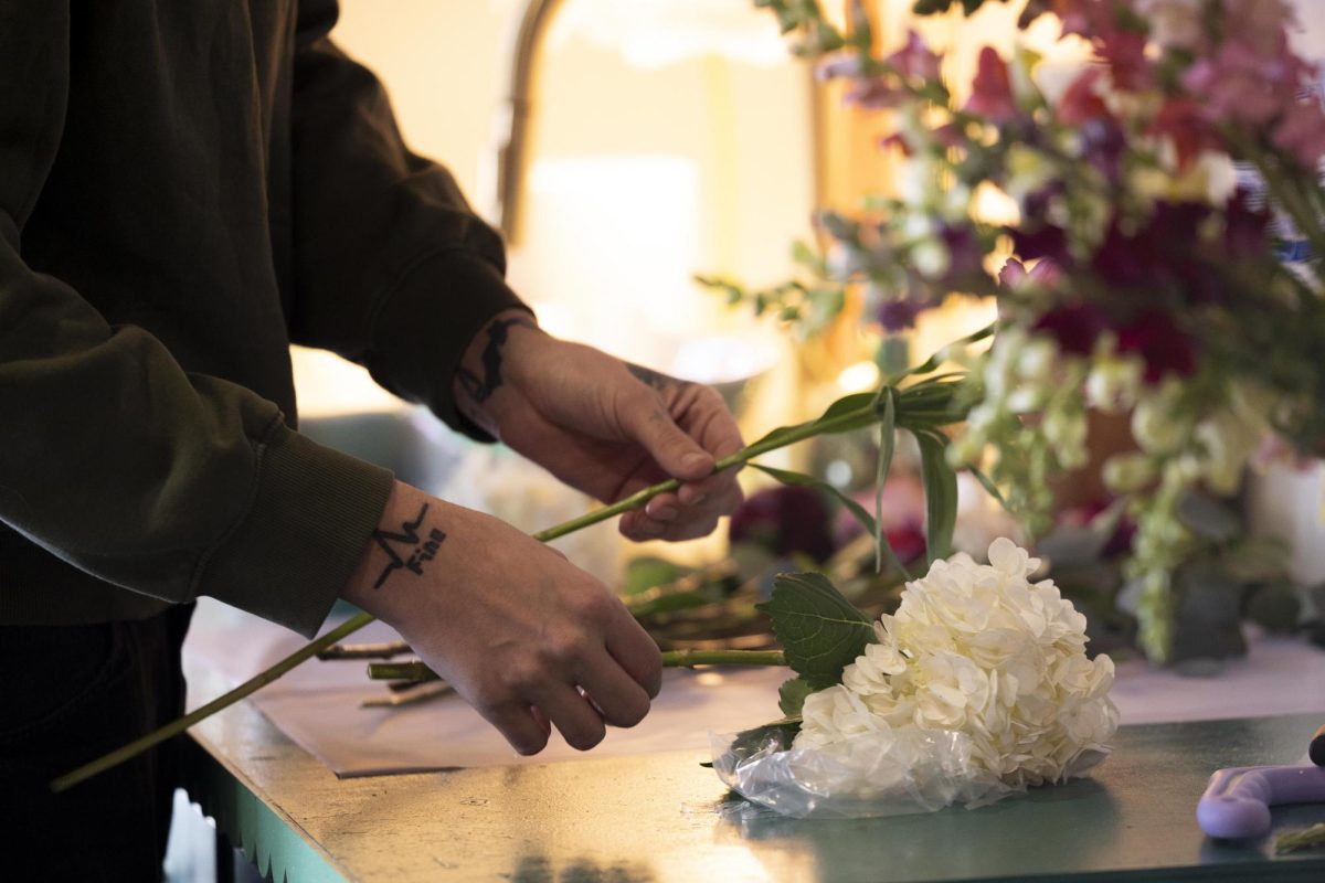 Brian McCoy, a master florist hand picks flowers for a bouquet he makes on Saturday, Dec. 7, 2024, at Poppy's Flower Bar in Lexington, Kentucky. Photo by Christian Kantosky | Assistant Photo Editor