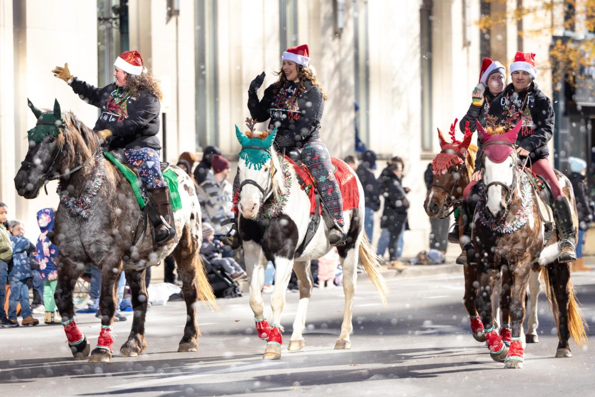 Parade participants ride horses down the route during the Lexington Holiday parade on Saturday, Dec. 7, 2024, at Main Street in Lexington, Kentucky. Photo by Sydney Yonker | Staff