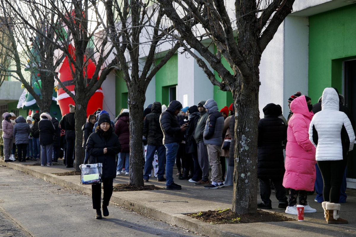 A woman walks to get in line during the Firefighter Toy Drive on Saturday, Dec. 14, 2024, at the Lexington Fire Fighter North Pole off New Circle Road in Lexington, Kentucky. Photo by Christian Kantosky | Assistant Photo Editor