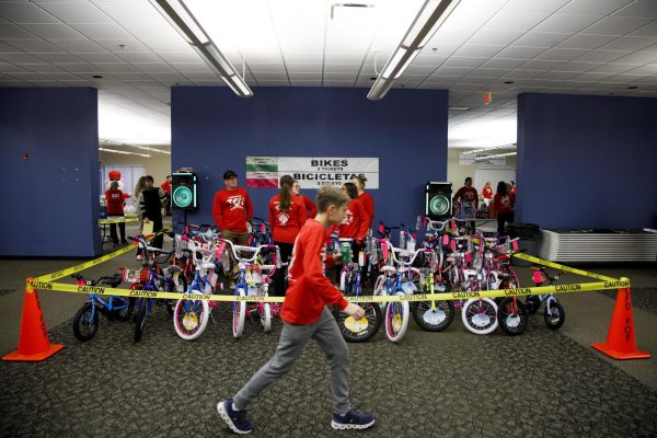 Volunteers set up stations last minute before the Firefighter Toy Drive begins on Saturday, Dec. 14, 2024, at the Lexington Fire Fighter North Pole off New Circle Road in Lexington, Kentucky. Photo by Christian Kantosky | Assistant Photo Editor