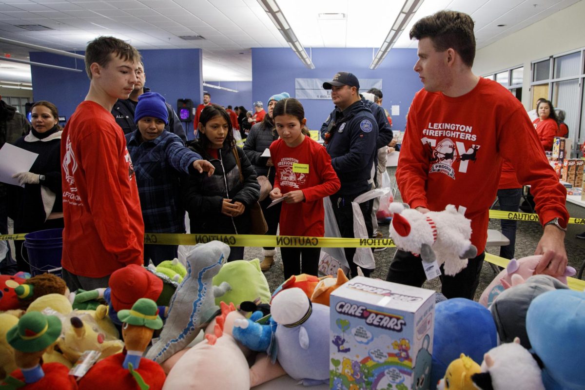 Volunteers help attendees choose gifts during the Firefighter Toy Drive on Saturday, Dec. 14, 2024, at the Lexington Fire Fighter North Pole off New Circle Road in Lexington, Kentucky. Photo by Christian Kantosky | Assistant Photo Editor