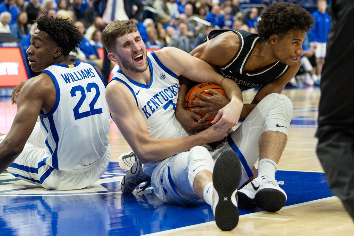 Kentucky Wildcats forward Andrew Carr (7) fights Brown Bears forward Landon Lewis (22) for the ball during the Kentucky vs. Brown men’s basketball game on Tuesday, Dec. 31, 2024, at Rupp Arena in Lexington, Kentucky. Kentucky won 88-54. Photo by Sydney Yonker | Staff