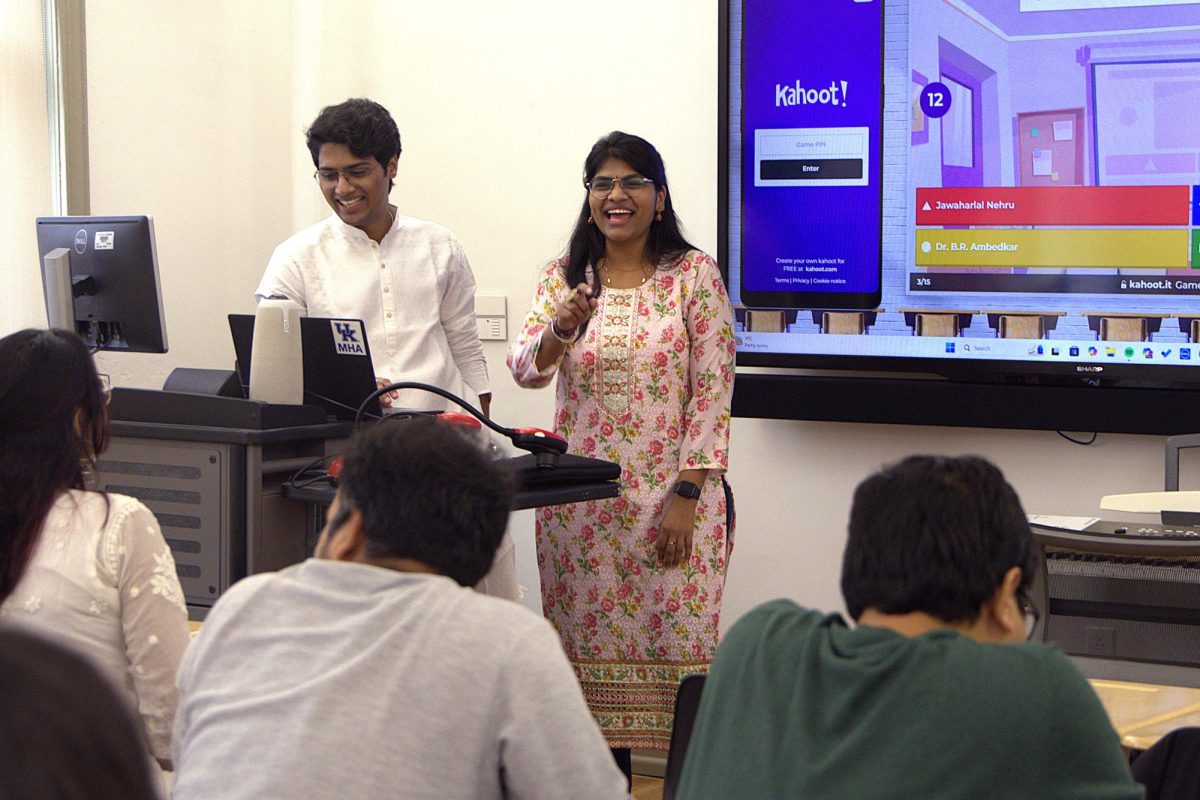 Hritika, the secretary of The Indian Wildcat Association, and Hritik, the event manager of The Indian Wildcat Association, laugh while leading a Kahoot! game during the Indian Republic Day Celebration on Sunday, Jan. 26, 2025, on the University of Kentucky's campus in Lexington, Kentucky. Photo by Mackenzie Walton | Staff