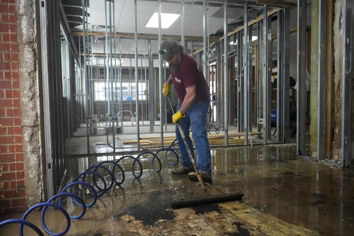 A clean-up crew sweeps standing water out of the office on Thursday, Feb. 20, 2025, at the Kevin W. Johnson Attorney at Law office in Hazard, Kentucky. Photo by Matthew Mueller | Staff