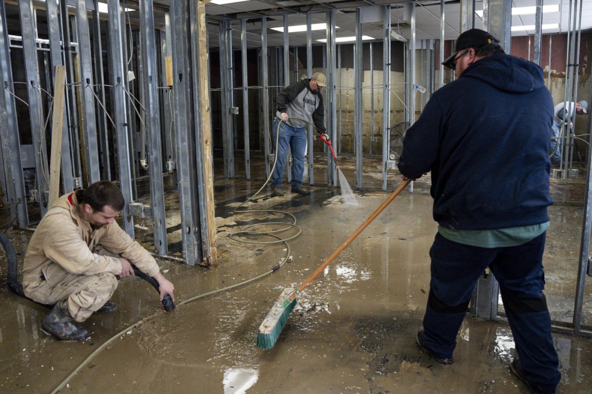 A clean up crew pressure washes and drains water from an office building on Thursday, Feb. 20, 2025, at the Kevin W. Johnson Attorney at Law office in Hazard, Kentucky. Photo by Christian Kantosky | Assistant Photo Editor