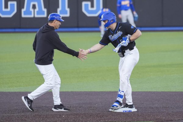 Kentucky outfielder Will Marcy (11) high-fives Kentucky head coach Nick Mingione after he made it safe to second base during the baseball game vs. Hofstra on Friday, Feb. 28, 2025, at Kentucky Proud Park in Lexington, Kentucky. Kentucky won 7-5. Photo by Matthew Mueller | Photo Editor