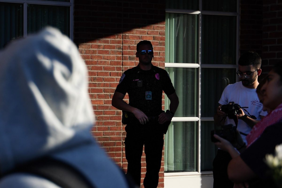 A UKPD police officer surveys a crowd on Monday, Oct. 7, 2024, outside of the William T. Young Library in Lexington, Kentucky. Photo by Abbey Cutrer | Staff