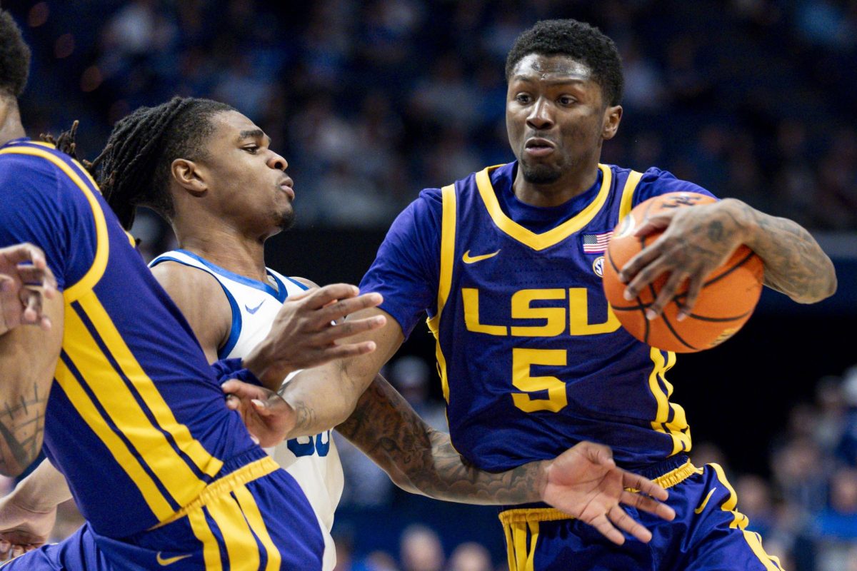 LSU Tigers guard Cam Carter (5) is fouled by Kentucky Wildcats guard Otega Oweh (00) during the basketball game vs. the LSU Tigers on Tuesday, March 4, 2025, at Rupp Arena in Lexington, Kentucky. Kentucky won 95-64. Photo by Christian Kantosky | Assistant Photo Editor