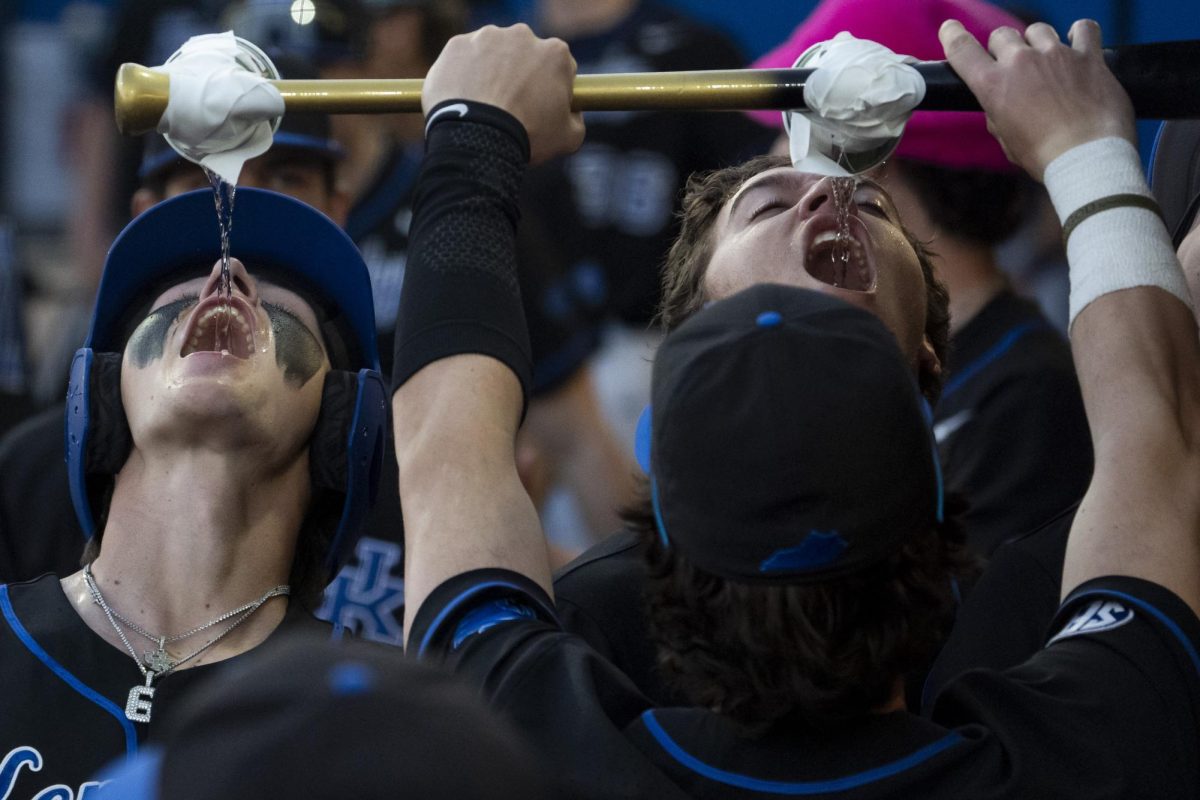 Kentucky infielder Tyler Bell (6) drinks water from a bat after scoring a run during the baseball game vs. NIU on Tuesday, March. 11, 2025, at Kentucky Proud Park in Lexington, Kentucky.  Photo by Matthew Mueller | Photo Editor