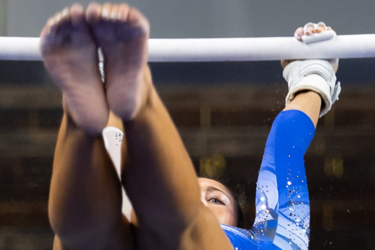 Kentucky Wildcat Gymnast, Delaynee Rodriguez, reaches for the top bar as she performs her bar routine during the Senior Night meet vs. Arkansas on Friday, Mar. 7, 2025, at Historic Memorial Coliseum in Lexington, Kentucky. Kentucky won 197.925-197.725. Photo by Jack Stamats | Staff
