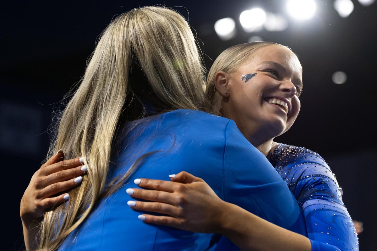 Kentucky Wildcat Gymnast, Creslyn Brose, hugs her coach after her beam routine during the Senior Night meet vs. Arkansas on Friday, Mar. 7, 2025, at Historic Memorial Coliseum in Lexington, Kentucky. Kentucky won 197.925-197.725. Photo by Jack Stamats | Staff