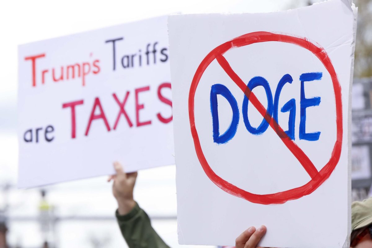 Protesters hold signs in the air during the “Hands Off!” protest on Saturday, April. 5, 2025, at Robert F. Stephens Courthouse Plaza in Lexington, Ky Photo by Matthew Mueller | Photo Editor