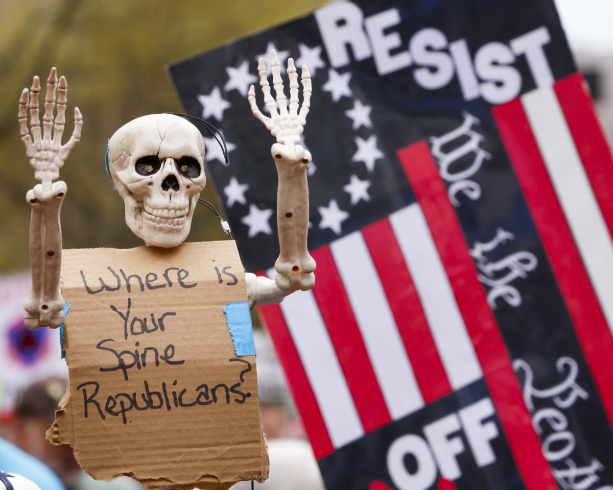 A protester holds a skeleton that reads “Where is your spine Republicans?” during the “Hands Off!” protest on Saturday, April. 5, 2025, at Robert F. Stephens Courthouse Plaza in Lexington, Ky Photo by Matthew Mueller | Photo Editor