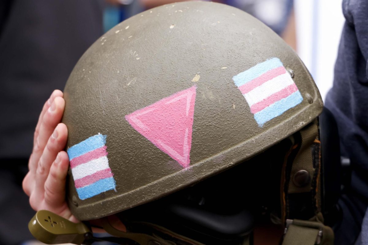 A protester holds a combact helmet with the Transgender flag painted on it during the “Hands Off!” protest on Saturday, April. 5, 2025, at Robert F. Stephens Courthouse Plaza in Lexington, Ky Photo by Matthew Mueller | Photo Editor