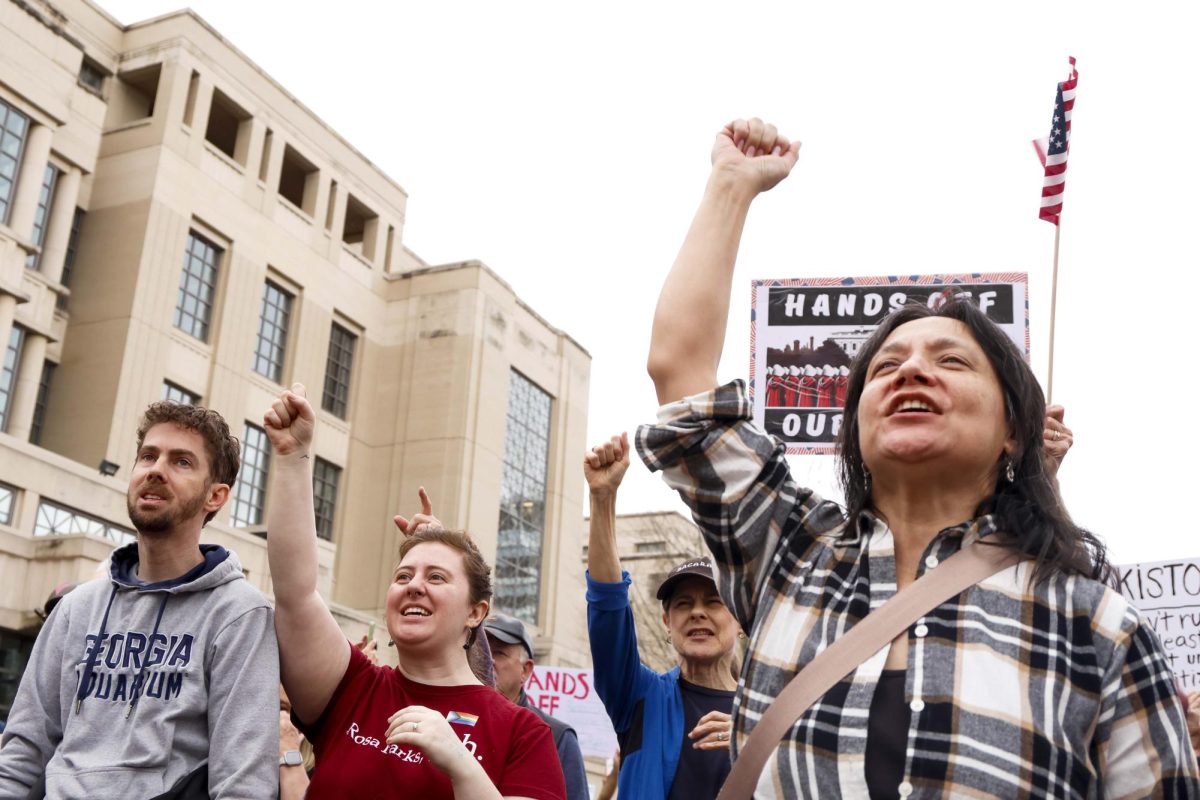 Protesters raise their fists in the air during the “Hands Off!” protest on Saturday, April. 5, 2025, at Robert F. Stephens Courthouse Plaza in Lexington, Ky Photo by Matthew Mueller | Photo Editor