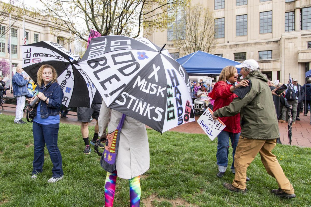 People watch as friends embrace during the “Hands Off!” protest on Saturday, April 5, 2025, at Robert F. Stephens Courthouse Plaza in Lexington, Ky. Photo by Christian Kantosky | Assistant Photo Editor