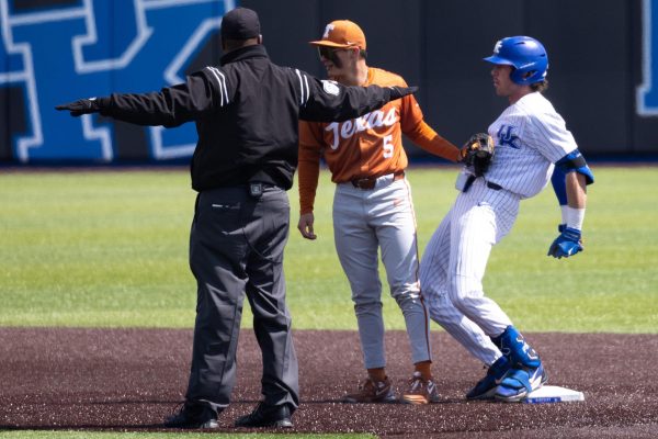 Kentucky wildcats outfielder James McCoy (13) celebrates a double while Texas Longhorns infielder Ethan Mendoza keeps a tag on him incase he steps off the base during the Kentucky vs Texas baseball game on Saturday, Apr. 12, 2025 at Kentucky Proud Park in Lexington, Kentucky. Kentucky won 5-4. Photo by Sydney Yonker | Staff