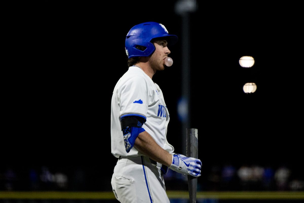 Kentucky utility James McCoy (13) blows a bubble with his gun during the Kentucky vs Louisville baseball game on Tuesday, Apr. 22, 2025 at Kentucky Proud Park in Lexington, Kentucky. Kentucky won 17-5. Photo by Sydney Yonker | Staff