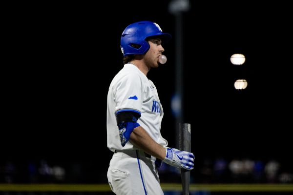 Kentucky utility James McCoy (13) blows a bubble with his gun during the Kentucky vs Louisville baseball game on Tuesday, Apr. 22, 2025 at Kentucky Proud Park in Lexington, Kentucky. Kentucky won 17-5. Photo by Sydney Yonker | Staff