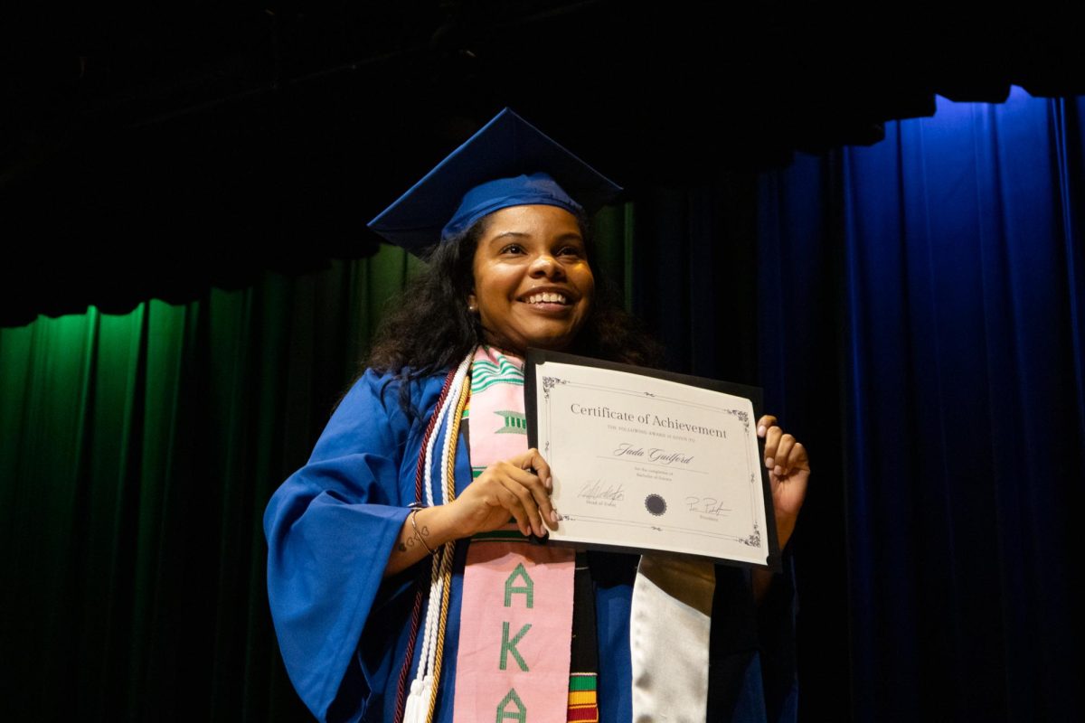 A UK senior smiles after receiving a certificate of achievement during the Senior Salute hosted by Alpha Phi Alpha on Wednesday, May 7, 2025, at Lyric Theatre & Cultural Arts Center  in Lexington, Kentucky. Photo by Sydney Novack | Staff