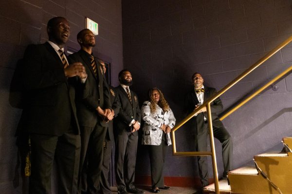 UK students, faculty, and speakers stand off stage listening to “Lift Every Voice and Sing” during the Senior Salute hosted by Alpha Phi Alpha on Wednesday, May 7, 2025, at Lyric Theatre & Cultural Arts Center  in Lexington, Kentucky. Photo by Sydney Novack | Staff