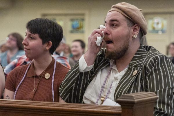 Jay Stringer-Vaught, right, a masters graduate in library science, wipes tears from their eyes during the Community Commencement on Friday, May 2, 2025, at Maxwell Street Presbyterian Church in Lexington, Ky. Photo by Christian Kantosky | Assistant Photo Editor