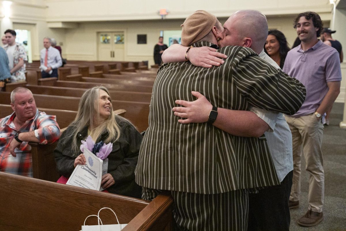 Jay Stringer-Vaught, surround by their family, is kissed by their husband after the Community Commencement on Friday, May 2, 2025, at Maxwell Street Presbyterian Church in Lexington, Ky. Photo by Christian Kantosky | Assistant Photo Editor
