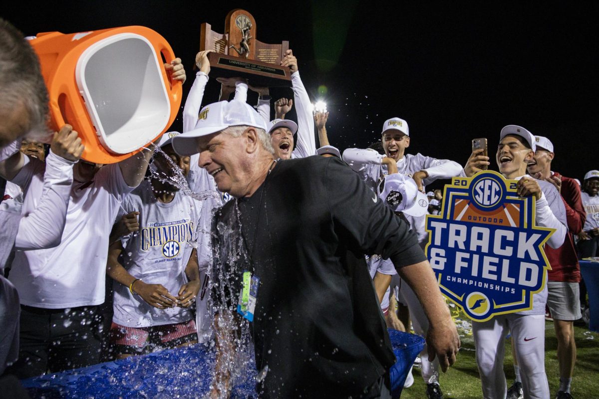Arkansas men’s track celebrates winning the SEC title by dumping water on Head Coach Chris Bucknam during the 2025 SEC Outdoor Championships on Saturday, May 17, 2025, at UK Outdoor Track and Field Facility in Lexington, Ky. Photo by Christian Kantosky | Photo Editor
