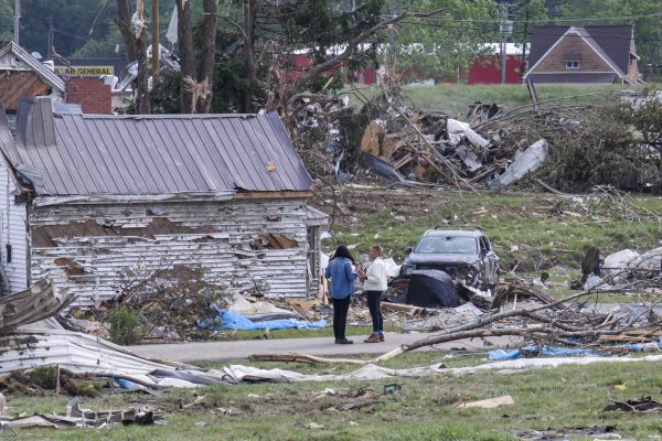 People, surrounded by homes which were destroyed, talk with each other on Tuesday, May 20, 2025, after an EF4 tornado hit London, Ky. Photo by Hannah Piedad | Staff