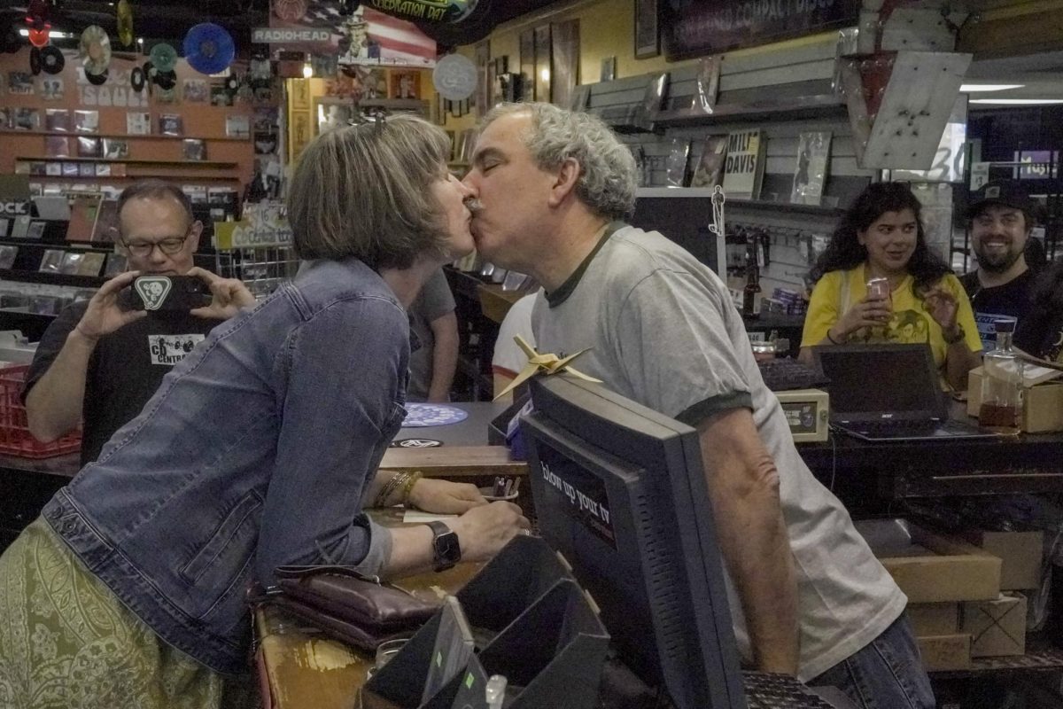 Owner Steve Baron, center, kisses his wife, Faye Baron, left, during the store's final day on Sunday, Sept. 8, 2025, at CD Central in Lexington, Ky. Faye Baron was the final customer before closing. Photo by Peyton Tindall | Staff