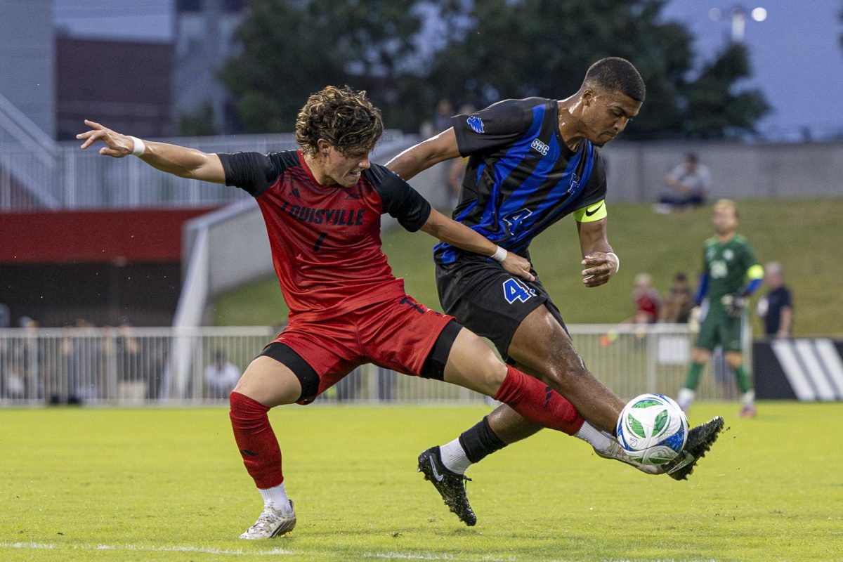 Loiusville Cardinals forward, Chase Vazquez (7), left,  and Kentucky Wildcats midfielder, Marqes Muir (4), right, fight for the ball during the soccer game against Louisville on Tuesday, Sept. 23, 2025, at Dr. Mark & Cindy Lynn Stadium in Louisville, Ky. Kentucky tied 2-2. Photo by Kenzie Cummings | Staff