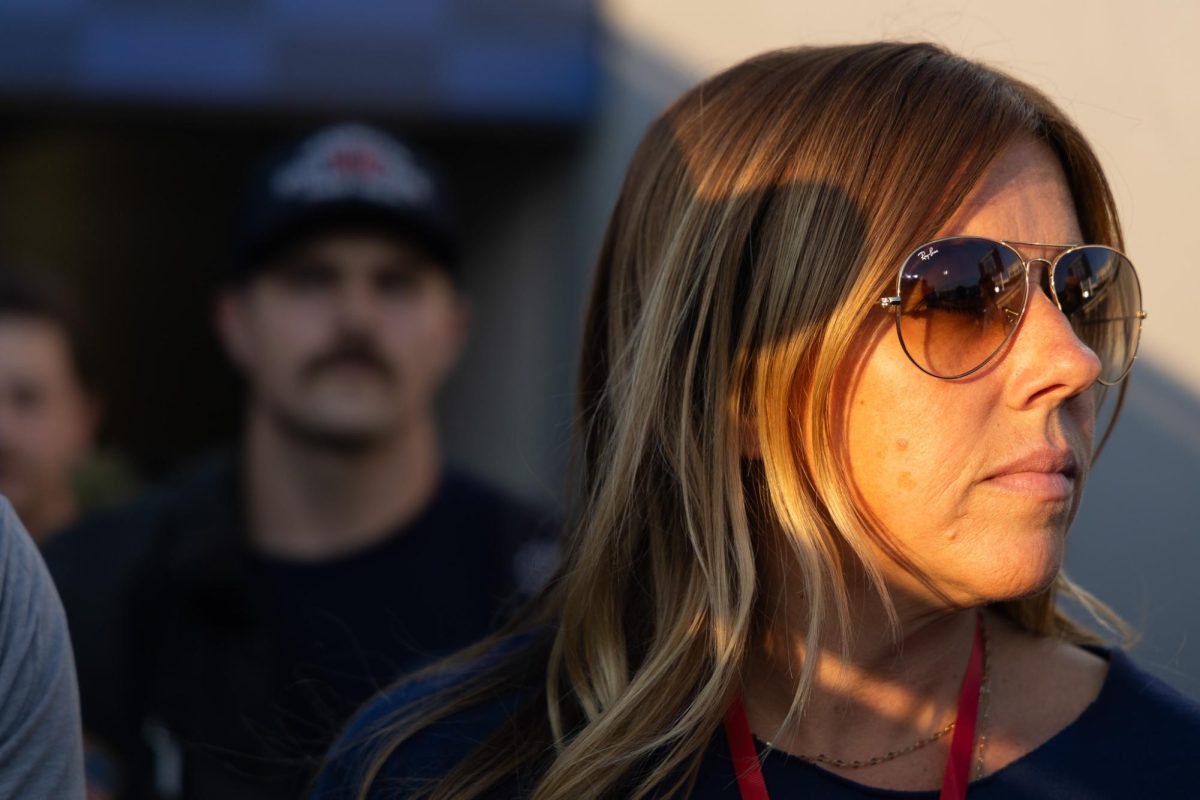 Kristen Kuveikis looks at stair climb particpants during moment of silence on Thursday, Sept. 11, 2025, at Kroger Field in Lexington, Ky. Kristen’s father, Thomas Kuveikis, died while on duty as a firefighter on Sept. 11, 2001. Photo by Isabella Sepahban | Staff