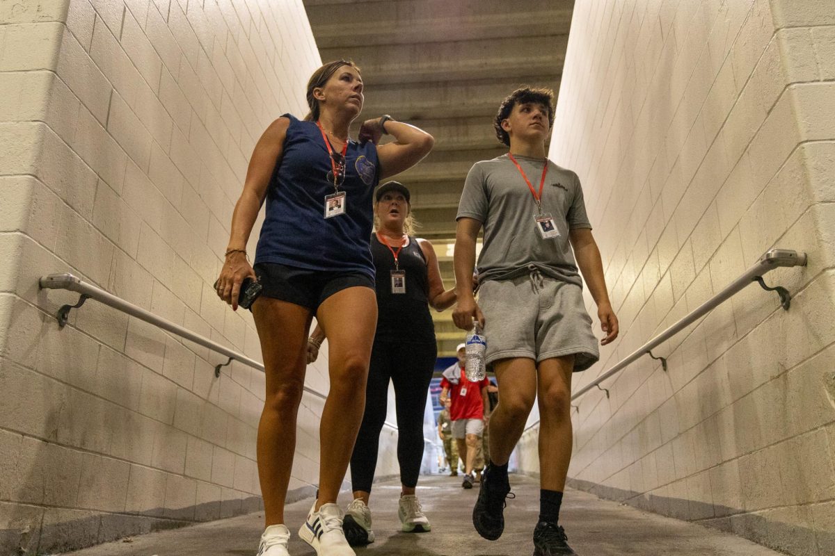 Kristen Kuveikis, left, Kristie Mack, center, and Aiden Hall, right, complete the first lap of the 9/11 Memorial Stair Climb on Thursday, Sept. 11, 2025, at Kroger Field in Lexington, Ky. DRAFT Photo by Isabella Sepahban | Staff