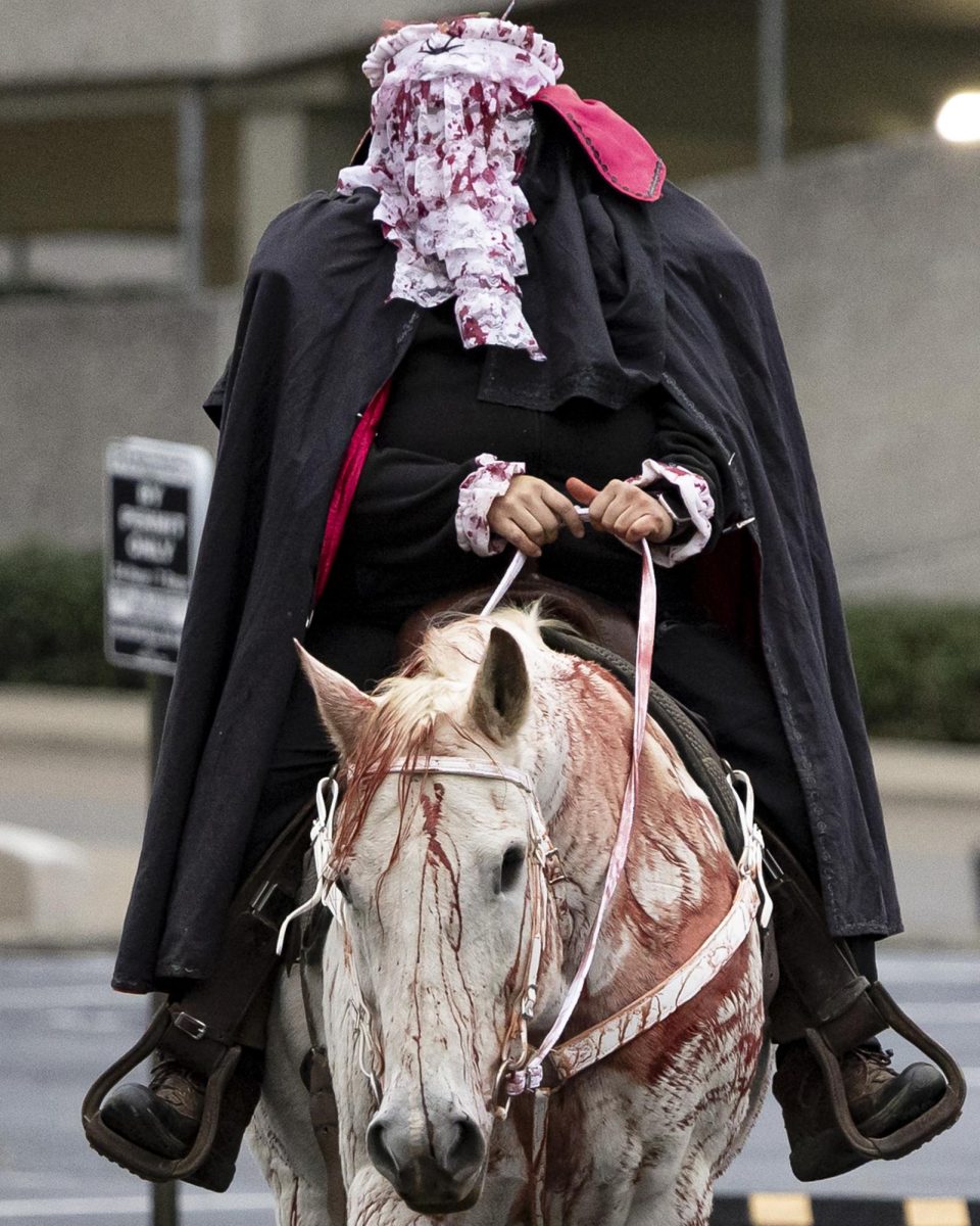  Horse and rider dressed as the Headless Horseman walk around during the Halloween & Thriller Parade on Sunday, Oct. 26, 2025, on East Main St. in Lexington, Ky. Photo by Kate Bonafede | Staff