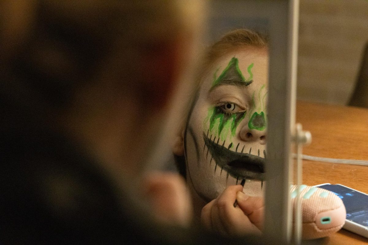 Reese Walker puts on her makeup before the haunted house on Thursday, Oct. 30, 2025, at Fright Nights Fear Tower in Winchester, Ky. Photo by Brooke Johnson | Staff