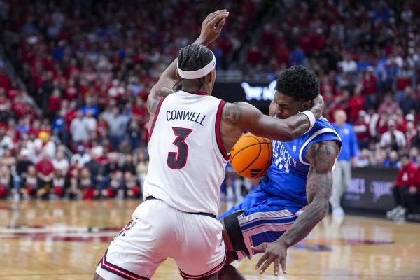 Louisville Cardinals guard Ryan Conwell (3) fouls Kentucky Wildcats guard Otega Oweh (00) during the men’s basketball game against Louisville on Tuesday, Nov. 11, 2025, at KFC Yum! Center in Louisville, Ky. Photo by Christian Kantosky | Photo Editor
