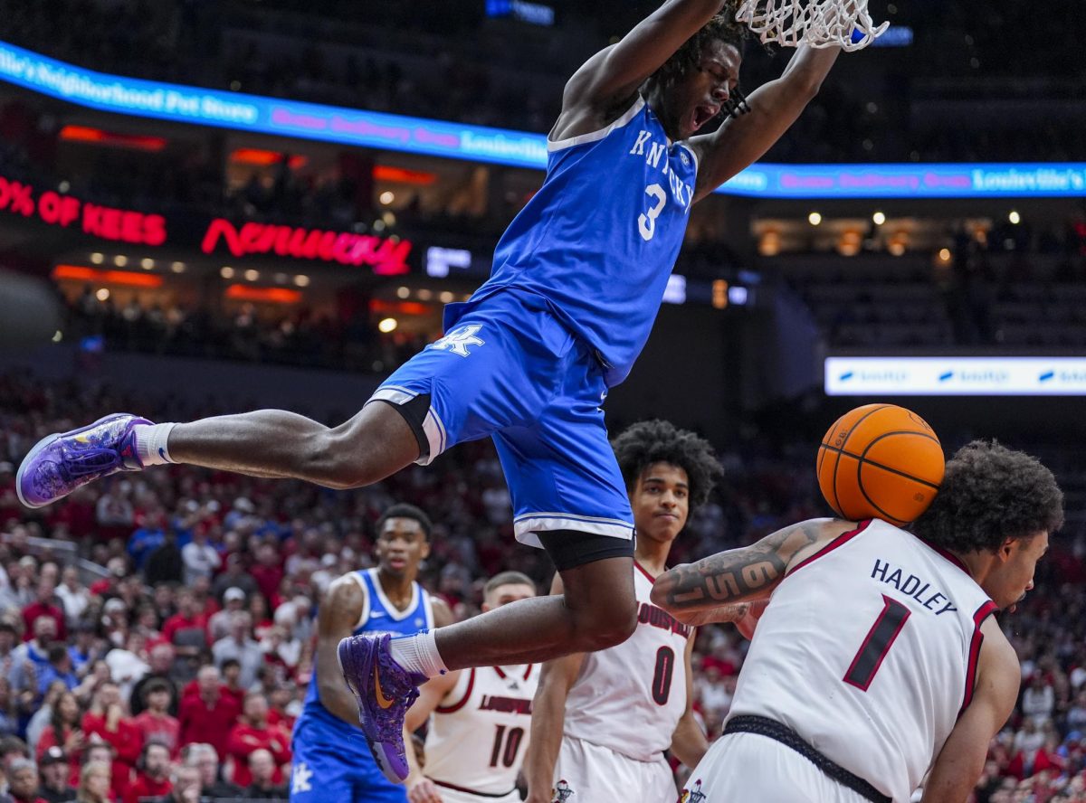Kentucky Wildcats guard Kam Williams (3) dunks over Louisville Cardinals guard J'Vonne Hadley (1) during the men’s basketball game against Louisville on Tuesday, Nov. 11, 2025, at KFC Yum! Center in Louisville, Ky. Louisville won 96-88. Photo by Christian Kantosky | Photo Editor