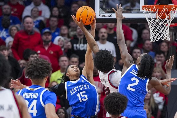 Kentucky Wildcats guard Jaland Lowe (15) blocks Louisville Cardinals guard Adrian Wooley (14) during the men’s basketball game against Louisville on Tuesday, Nov. 11, 2025, at KFC Yum! Center in Louisville, Ky. Louisville won 96-88. Photo by Christian Kantosky | Photo Editor