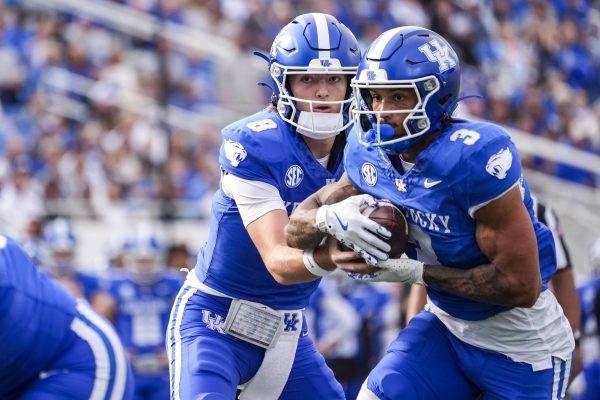Kentucky Wildcats quarterback Cutter Boley hands off the ball to Kentucky Wildcats running back Seth McGowan during the football game against Tennessee Tech on Saturday, Nov. 15, 2025, at Kroger Field in Lexington, Ky. Photo by Christian Kantosky | Photo Editor