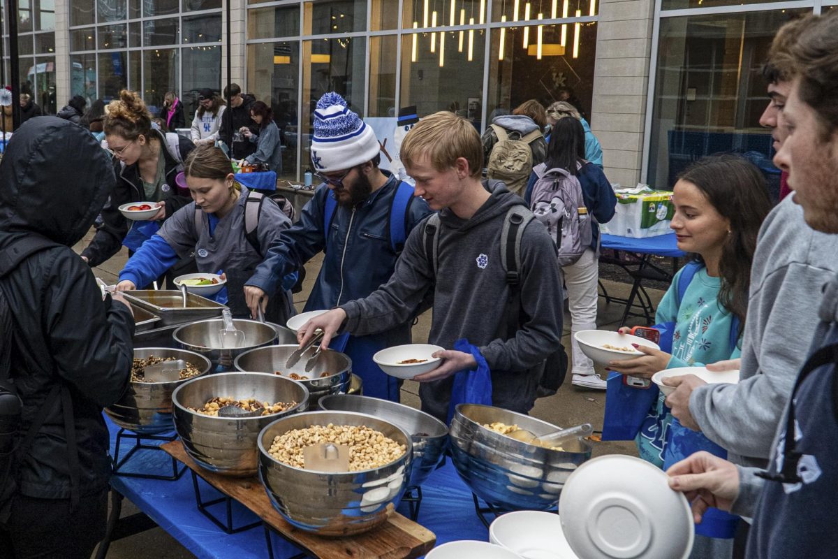 Students serve themselves food during the Winter Market event outside of Lewis Honors College on Wednesday, Nov. 19, 2025 in Lexington, Ky. Photo by Matias Dauelsberg | Staff