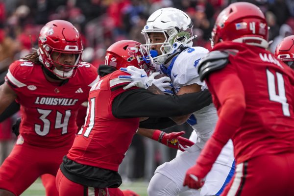 Louisville Cardinals defensive back D'Angelo Hutchinson tackles Kentucky Wildcats running back Seth McGowan during the football game against Louisville on Saturday, Nov. 29, 2025, at L&N Federal Credit Union Stadium in Louisville, Ky. Photo by Christian Kantosky | Photo Editor