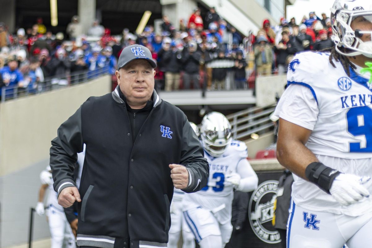 Kentucky Wildcats head coach Mark Stoops runs onto the field during the football game against Louisville on Saturday, Nov. 29, 2025, at L&N Federal Credit Union Stadium in Louisville, Ky. Louisville won 41-0. Photo by Christian Kantosky | Photo Editor