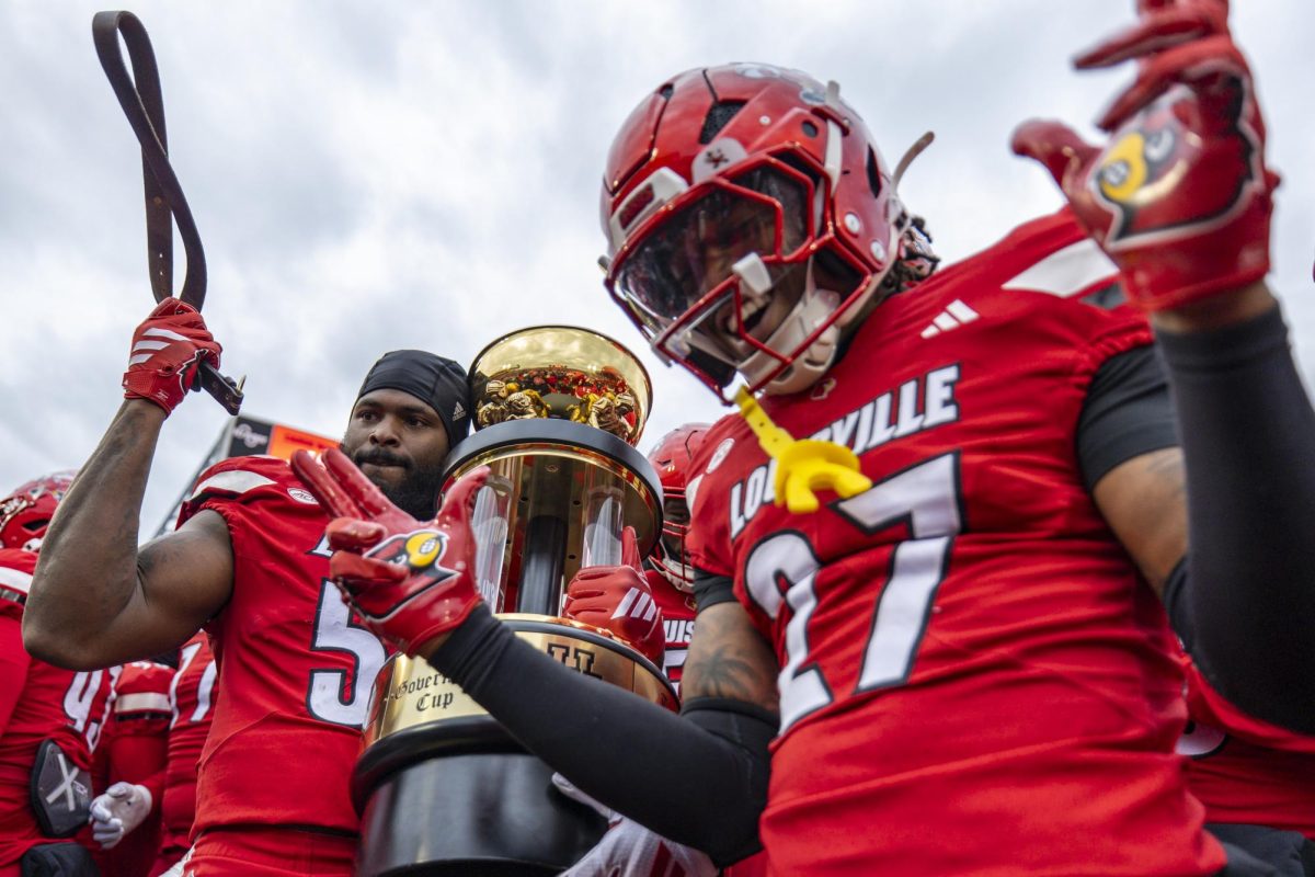 Louisville Cardinals defensive back Jojo Evans Jr. (27) and Louisville Cardinals offensive lineman Jimmy Williams III (55) with ‘The Governor’s Cup’ trophy after the football game against Kentucky on Saturday, Nov. 29, 2025, at L&N Federal Credit Union Stadium in Louisville, Ky. Louisville won 41-0. Photo by Christian Kantosky | Photo Editor