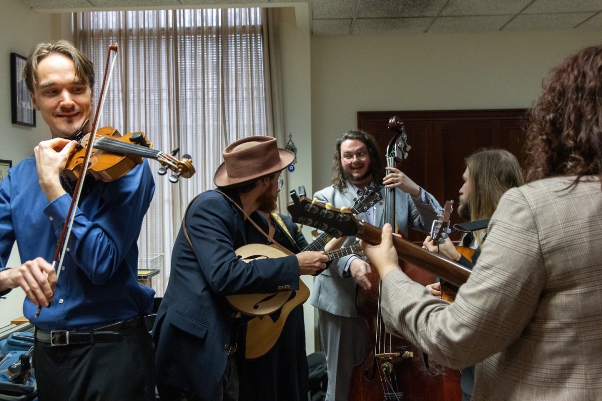 Members of the Berea College Bluegrass Ensemble prepare for their performance on Friday, Nov. 21, 2025, at Lucille Little Fine Arts Library in Lexington, Ky. Photo by Brooke Johnson | Staff
