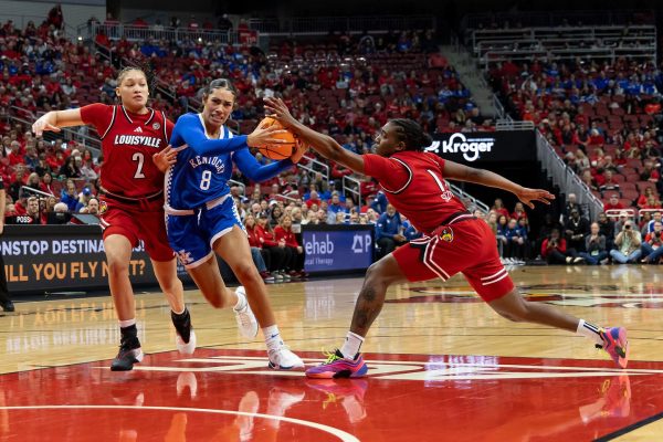 Kentucky guard Asia Bonne (8) drives the ball through Louisville defenders during the women’s basketball game against Louisville on Saturday, Nov. 21, 2025, at KFC Yum! Center in Louisville, Ky. Photo by Kate Bonafede | Staff