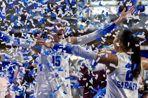 Kentucky’s Lizzie Carr (15) hugs her teammate Ava Sarafa (2) while the confetti falls after the volleyball match between Arkansas and Kentucky, where the Wildcats defeated the Razorbacks with a final score of 3-0 on Nov. 16th, 2025, at Historic Memorial Coliseum in Lexington, Ky. Photo by Xavier Patterson | Staff