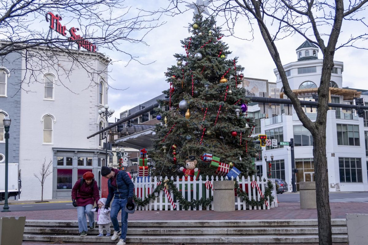 Families visit the Christmas Tree before its lighting at Holiday Lighting Festival on Sunday, Nov. 30, 2025 at Triangle Park in Lexington, Ky. Photo by Sammy Wynn | Staff